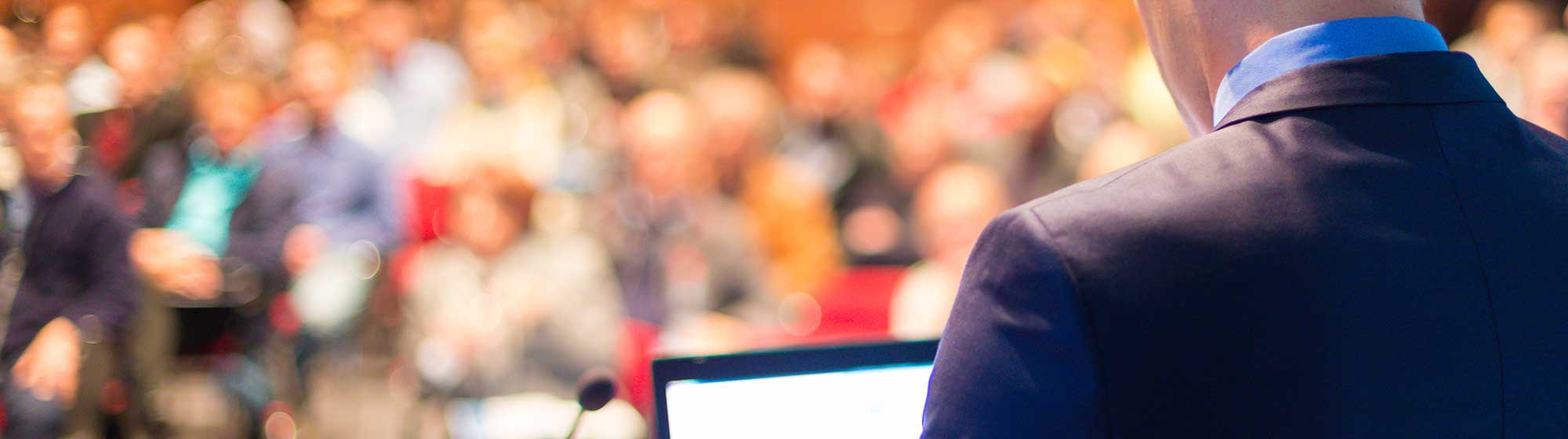 Man holding a press conference in front of an audience